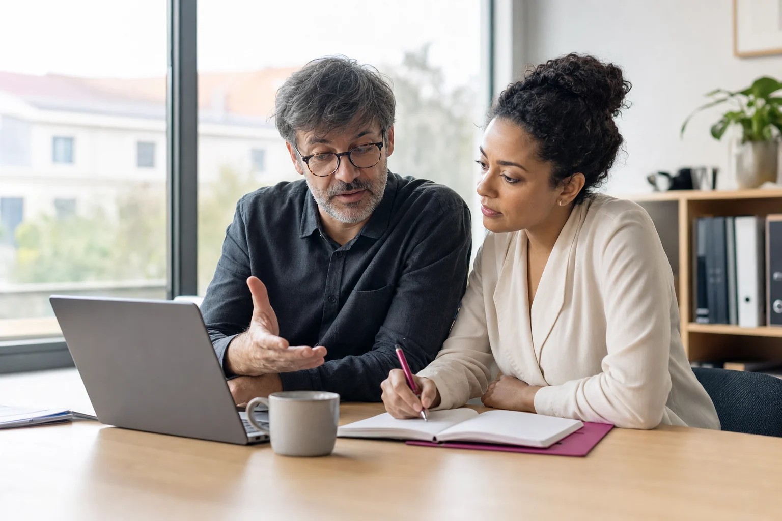 Finance and client-service leads agreeing the next action on a receivable
